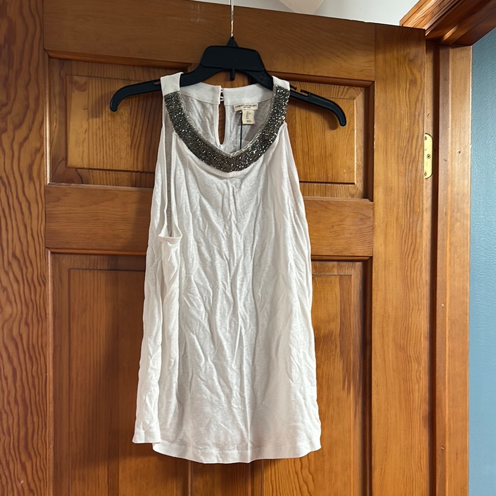 Elegant White Sleeveless Top with Embellished Neckline